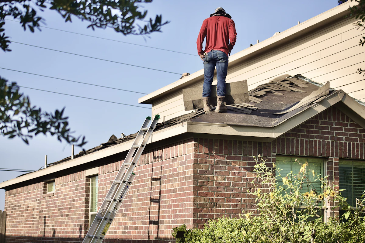 Inspector standing on a residential roof during a professional roof inspection