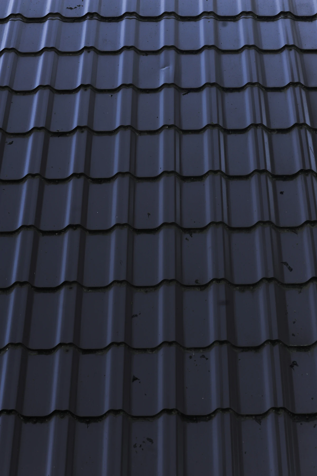 Close-up of a standing seam metal roof against a clear sky